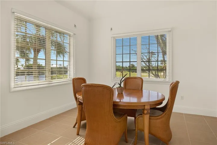 Dining space featuring light tile patterned floors