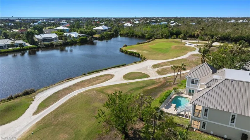 Birds eye view of property with a water view