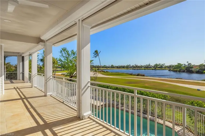 Balcony with ceiling fan and a water view