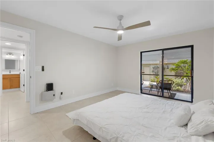 Bedroom featuring access to outside, ceiling fan, and light tile patterned floors