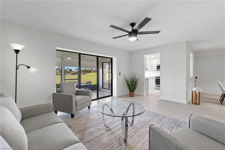 Living room featuring light tile patterned flooring and ceiling fan
