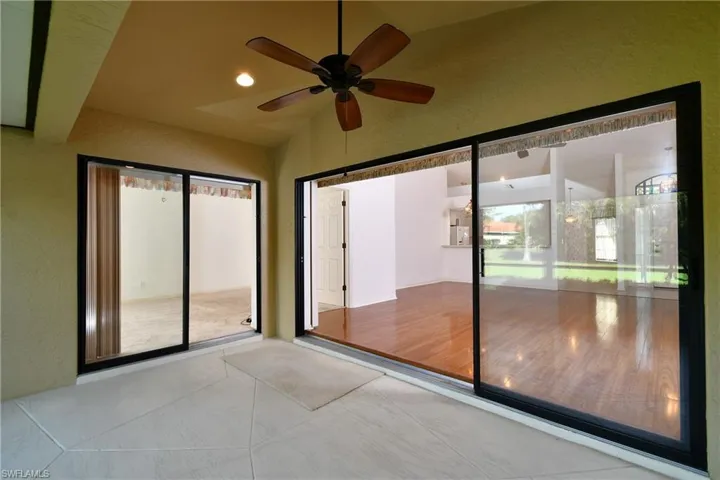 View from the lanai of the two slider doors leading into the Master BR and the LR