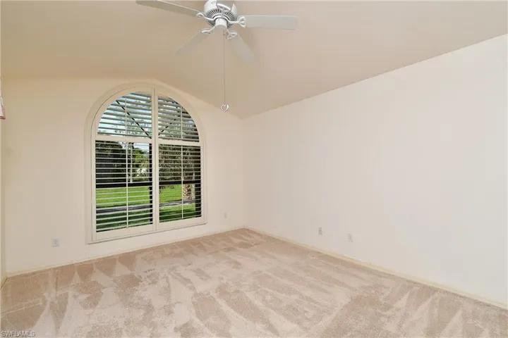 Another view of the Master with an arched window with plantation shutters