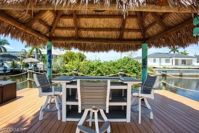 Dock area with a gazebo and a deck with water view