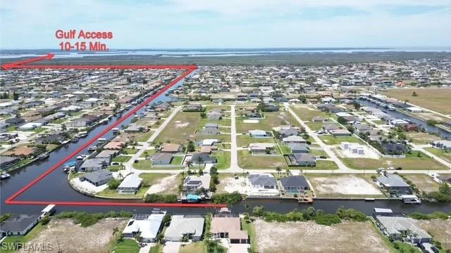 Aerial view of residential area featuring a nearby body of water