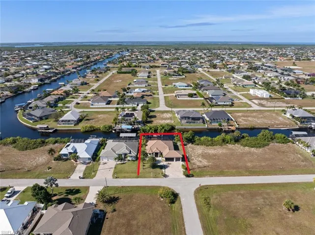 Aerial view of property's location featuring property parcel outlined and nearby suburban area