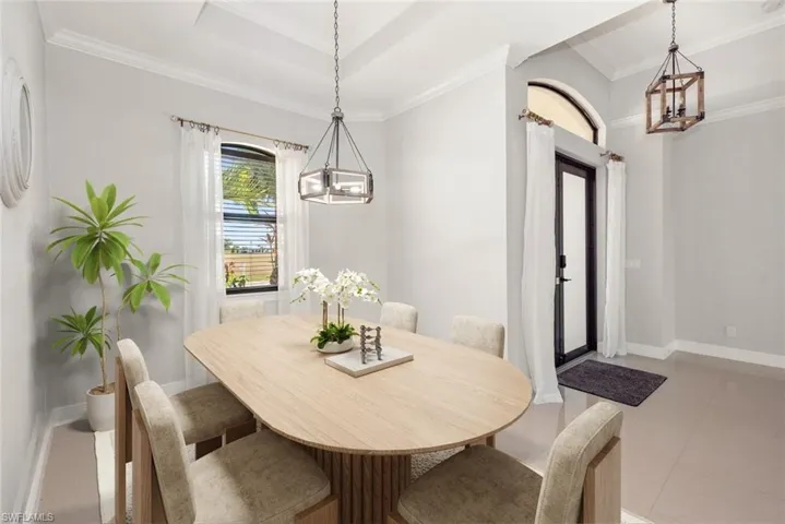 Dining area featuring a chandelier and ornamental molding