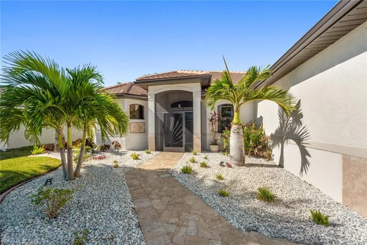 Entrance to property featuring stucco siding and a tile roof