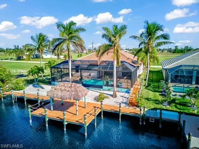 Dock with a sunroom, glass enclosure, a water view, and an outdoor pool