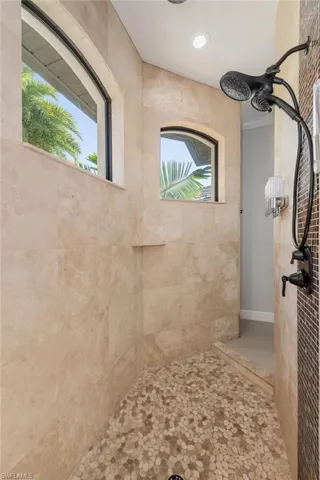 Bathroom featuring tiled shower and recessed lighting