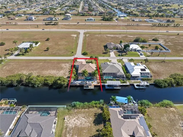Aerial perspective of suburban area featuring property parcel outlined and a large body of water