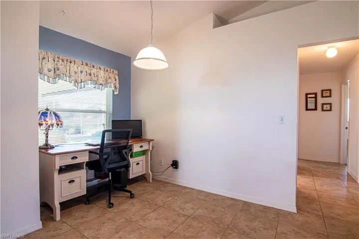 Tiled home office with lofted ceiling