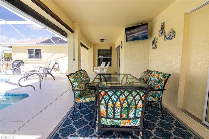 View of patio featuring glass enclosure