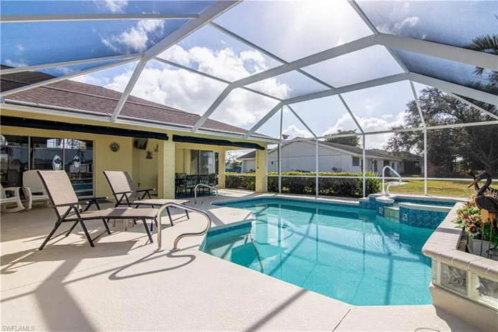 View of swimming pool with a patio and a lanai