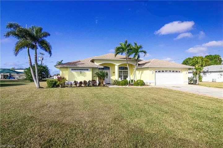 View of front of home with a front lawn and a garage