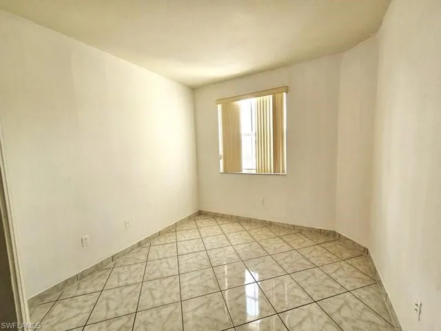 Unfurnished room with light tile patterned floors