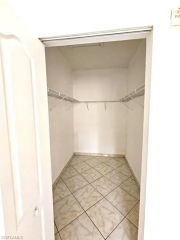 Spacious closet featuring light tile patterned floors