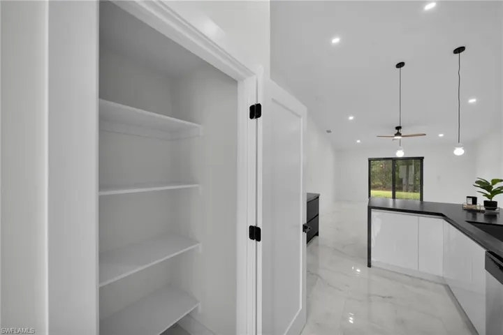 Hallway with recessed lighting and marble finish floor