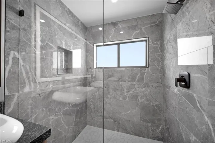 Bathroom with a sink and a marble finish shower