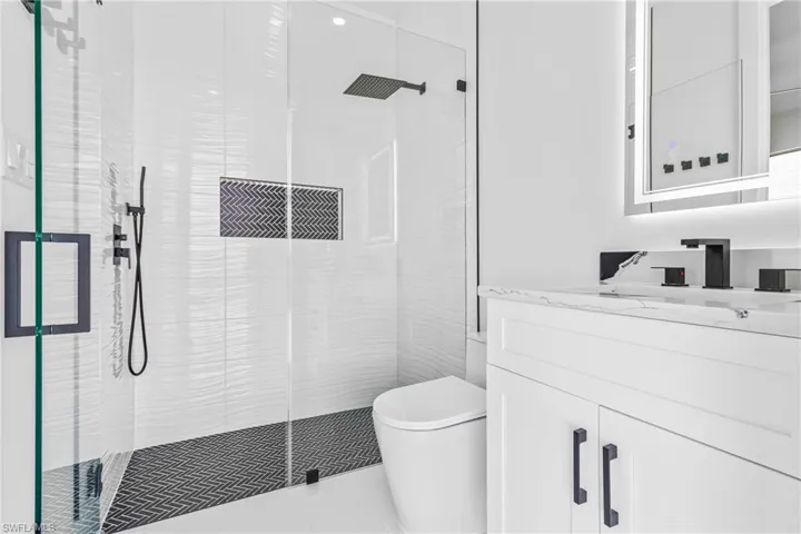Full bathroom with a stall shower and vanity