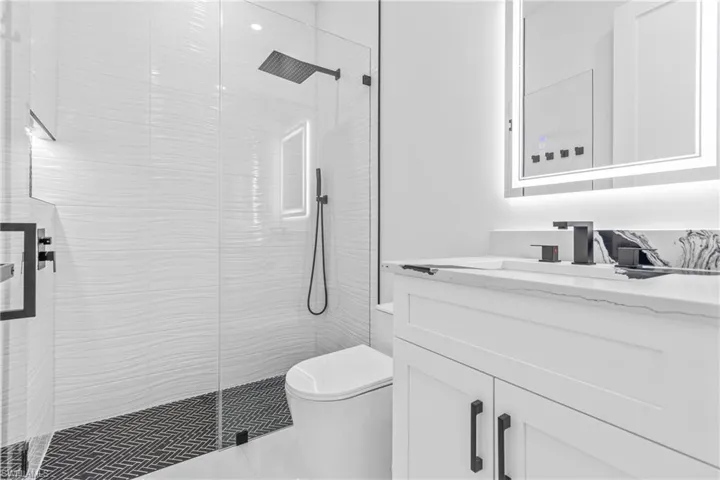 Full bath featuring vanity and a stall shower