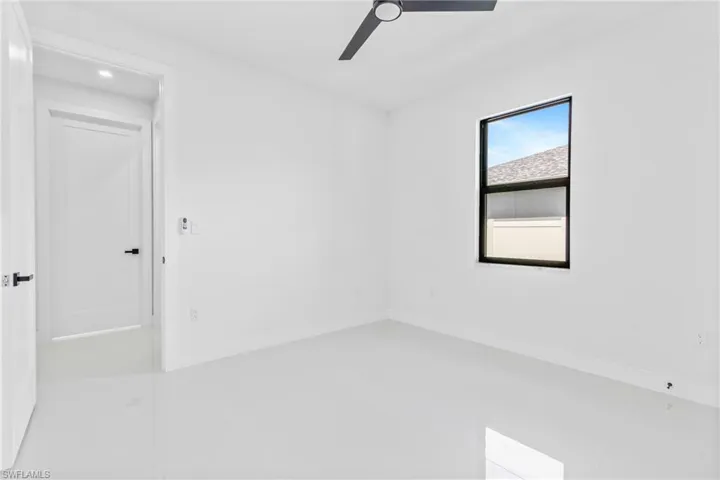 Spare room with a ceiling fan, light tile patterned floors, and recessed lighting