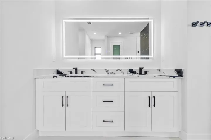 Bathroom featuring double vanity and recessed lighting