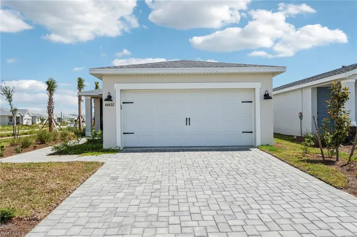 Garage featuring decorative driveway