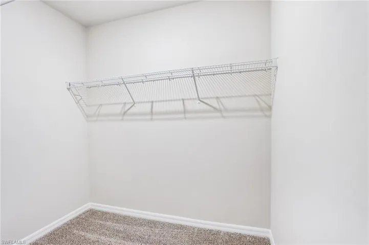 Walk in closet featuring carpet flooring