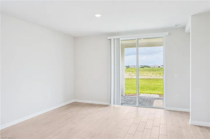 Unfurnished room with light wood-type flooring, baseboards, and recessed lighting