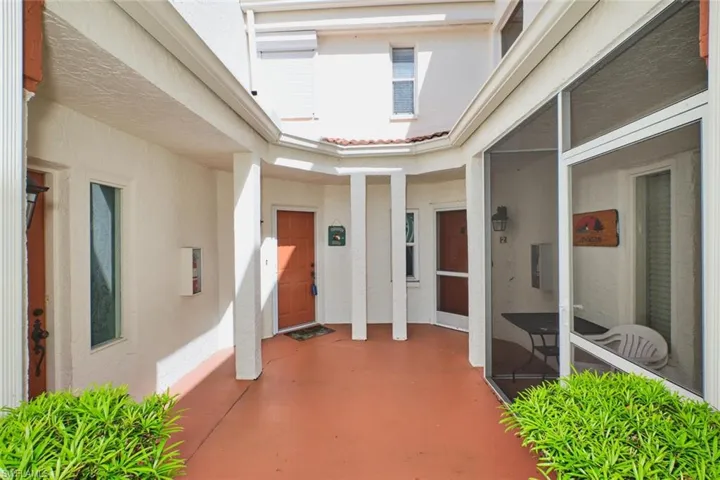 Entrance to property featuring stucco siding