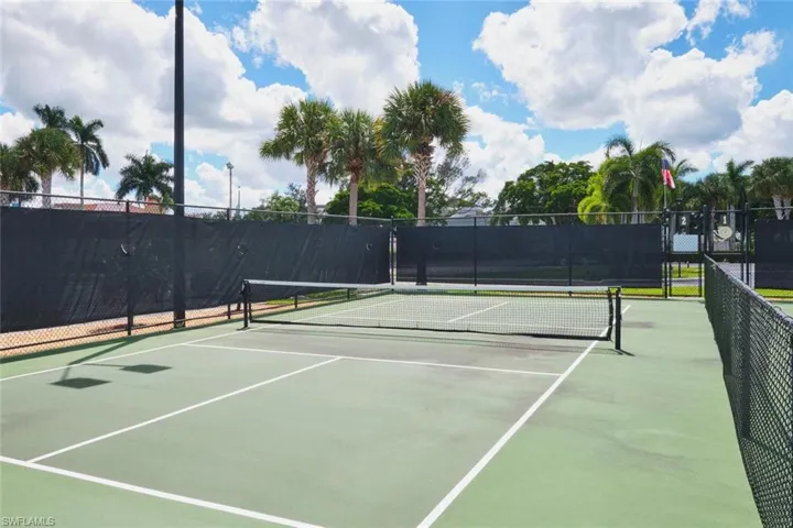 View of tennis court featuring community basketball court