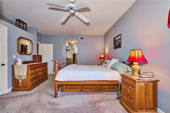 Carpeted bedroom featuring baseboards and ceiling fan