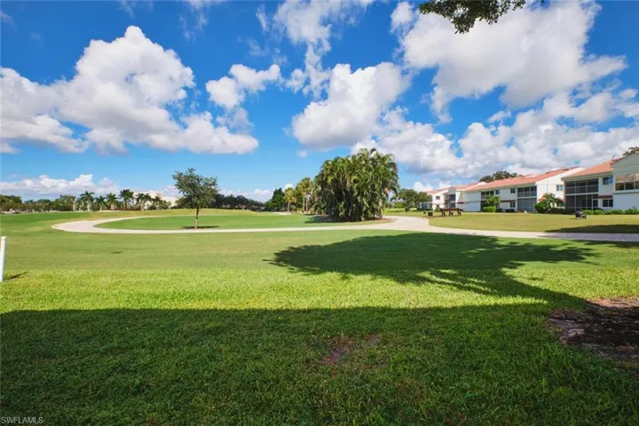 Surrounding community featuring a yard and view of golf course