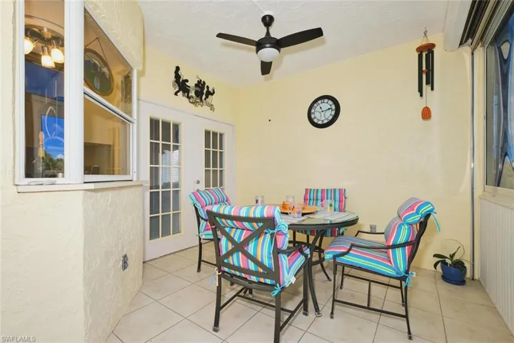 View of patio featuring ceiling fan, radiator, and outdoor dining space