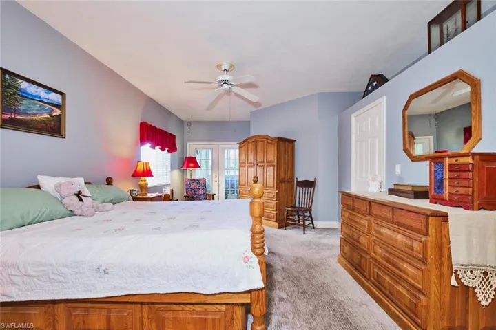 Bedroom featuring light carpet and a ceiling fan