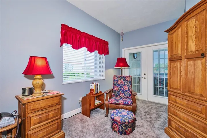 Primary Bedroom Sitting Area with French doors to Enclosed Lanai