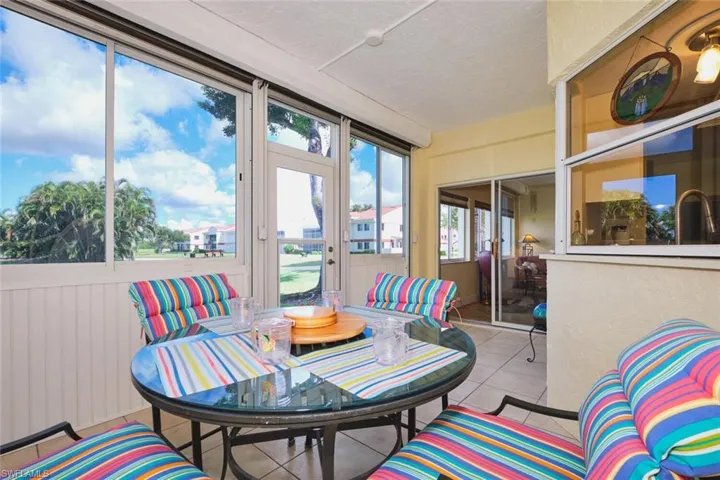 Sunroom / solarium with tile patterned flooring and a sink