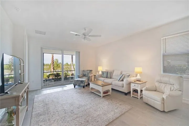 Open and Spacious Great Room w/light plank tile flooring & all very new furniture & rugs convey with sale