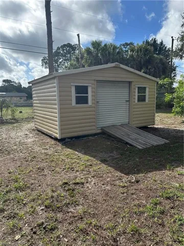 Freestanding shed with horizontal siding and a gable roof