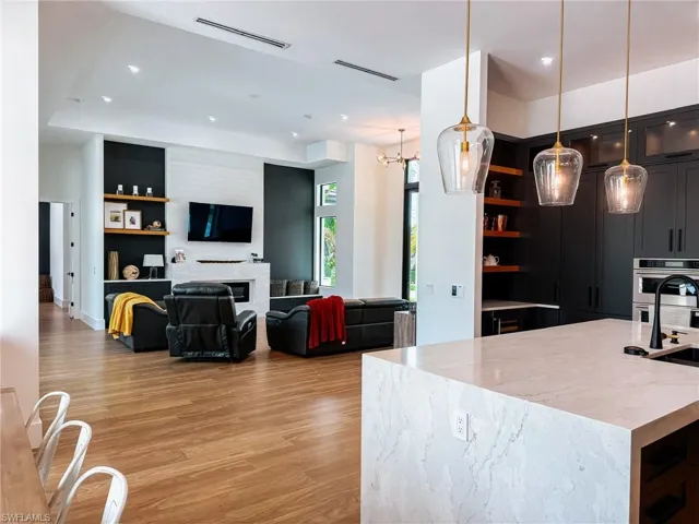 Open-concept living space featuring wood-finish flooring