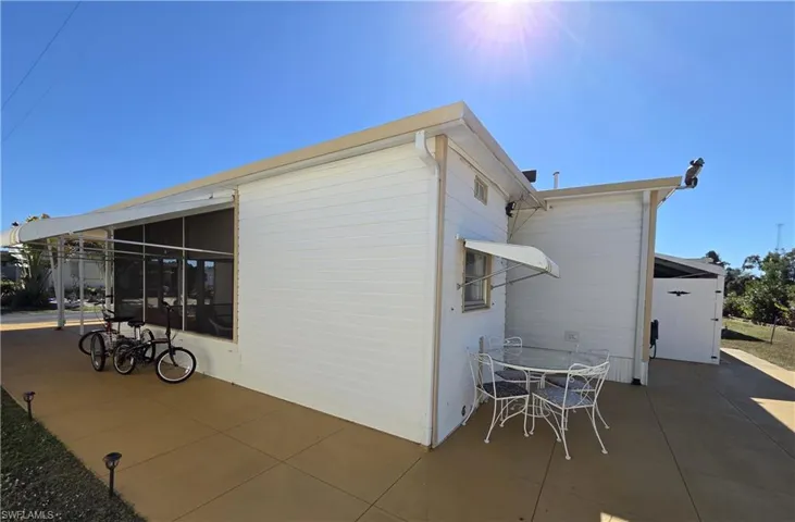 Wide walkway on the side of the unit provides extra parking for a vehicle AND allows you to drive your vehicle or golf cart to the rear of the property.