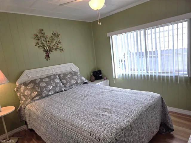Guest Bedroom with lots of natural light, ceiling fan, and lustrous laminate floors.