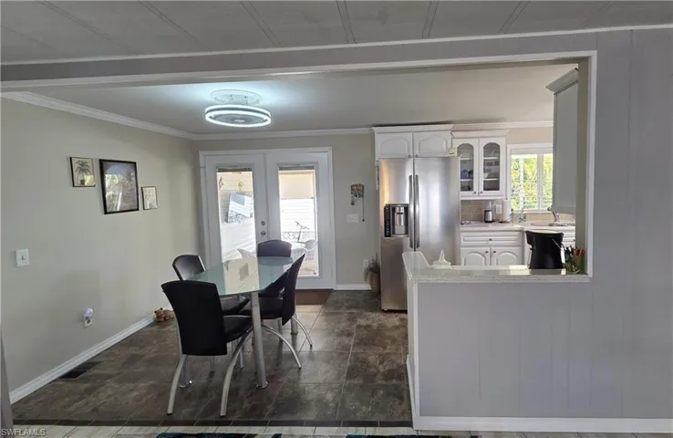 Dining area features a ceiling fan with light.