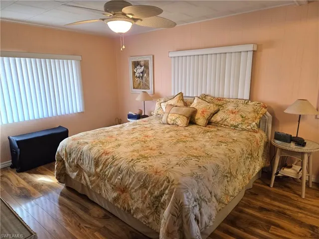 Primary Bedroom with beautiful laminate floor and ceiling fan.