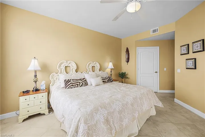 Bedroom with ceiling fan and light tile patterned floors