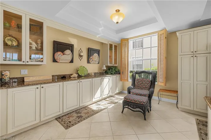 Sitting room featuring a tray ceiling and light tile patterned floors