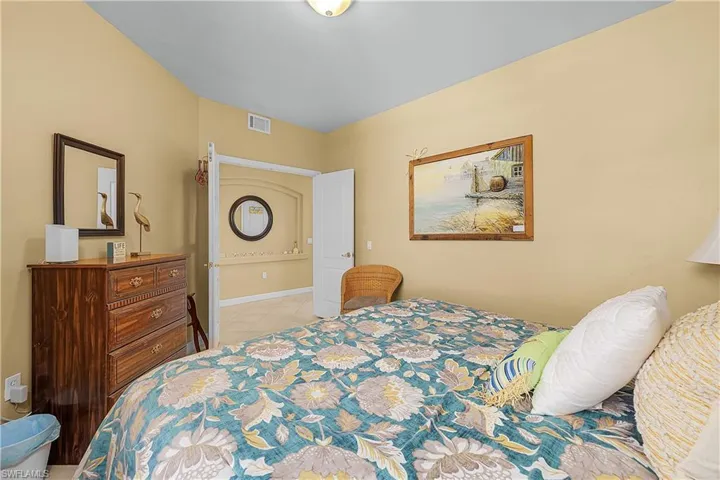 Bedroom featuring baseboards and light tile patterned flooring