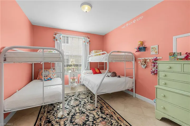 Bedroom featuring light tile patterned flooring and baseboards