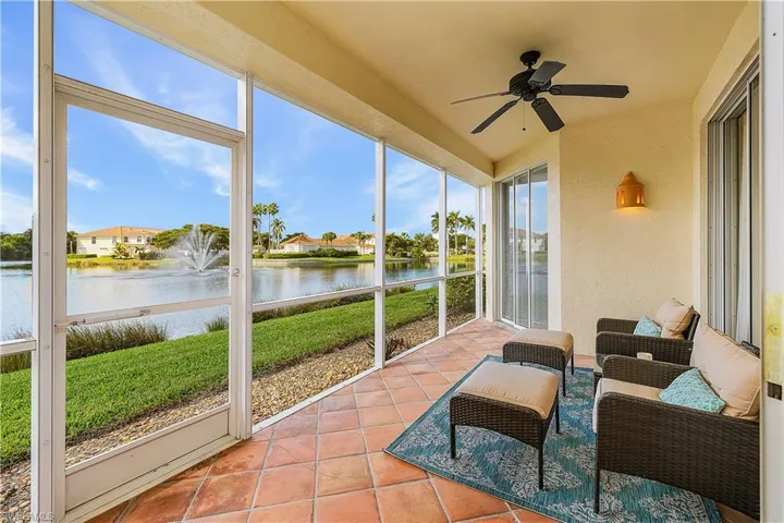 Sunroom with a water view and ceiling fan